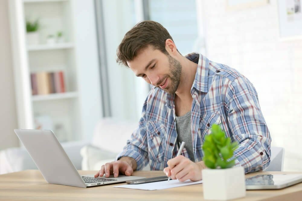 Businessman at home working on laptop